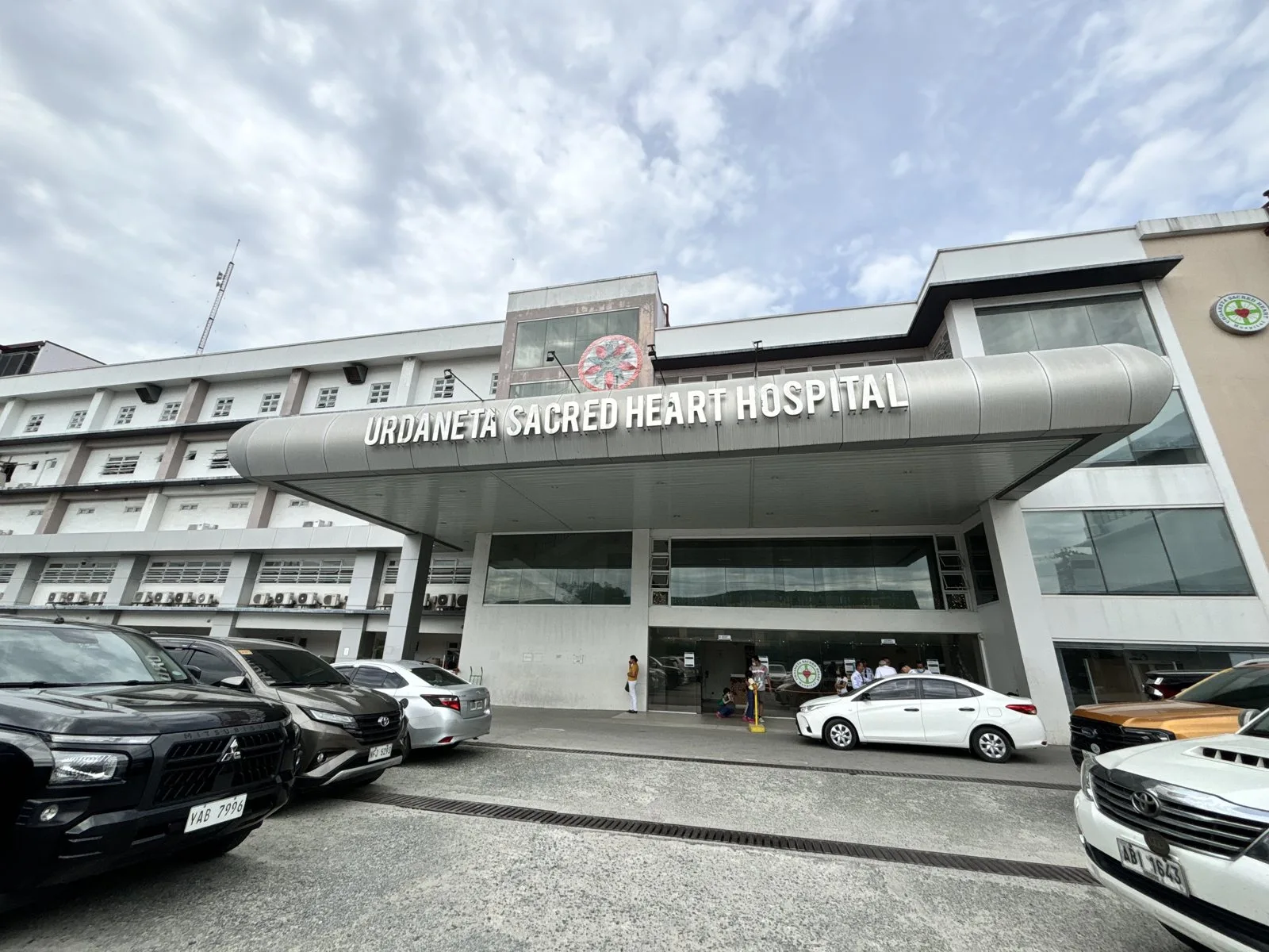 Street view of the Urdaneta Sacred Heart Hospital entrance along MacArthur Highway